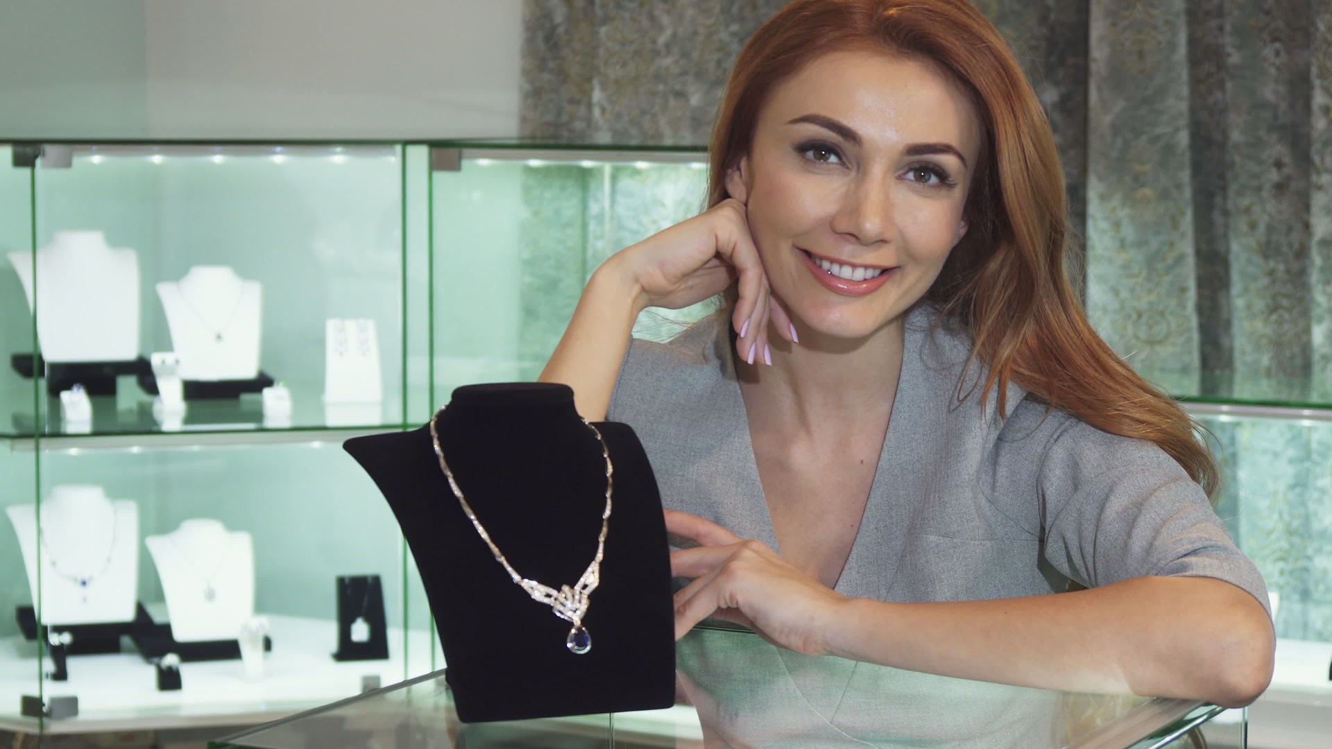 Happy beautiful woman touching diamond necklace smiling cheerfully