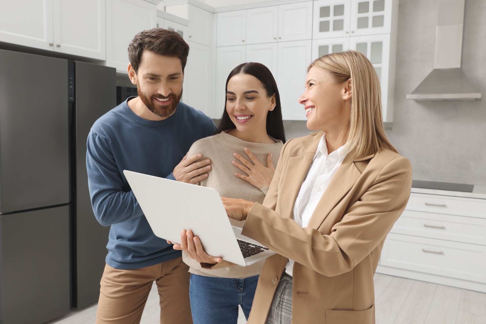 Real estate agent working with couple in new apartment